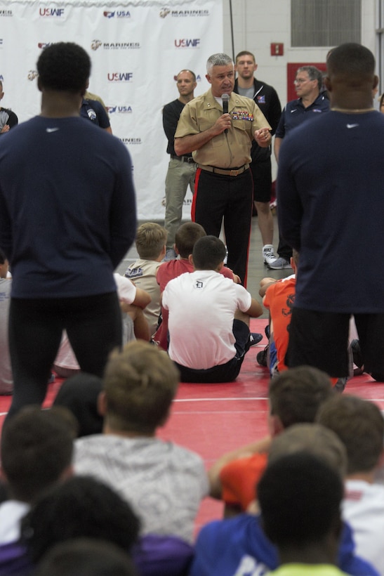 U.S. Marine Maj. Gen. Paul Kennedy, commanding general of Marine Corps Recruiting Command, addresses a crowd of local students and their parents and coaches during the MCRC Wrestling Clinic during Marine Week Detroit Sep. 9, 2017. Marines hosted many events during Marine Week Detroit as a part of their City Partnership Program. MCRC City Partnerships seek to align the Marine Corps with cities that share the essence of Marines - an irreducible fighting spirit. Some events hosted included High School visits supported by the Silent Drill Platoon, a Community Leaders Reception, a photography competition showcasing Detroit's fighting spirit, youth basketball and wrestling clinics, three on three basketball tournament, a cooking competition featuring an Expeditionary Field Kitchen, and more. MCRC leveraged existing partnerships with USA Wrestling, Women's Basketball Coaches Association and local contacts in the city to create events in celebration of the emerging partnership. Other City Partnerships in development include Baltimore, New Orleans, Chicago, Dallas, and Oakland, California. (U.S. Marine Corps photo by Sgt. Nathan Wicks)