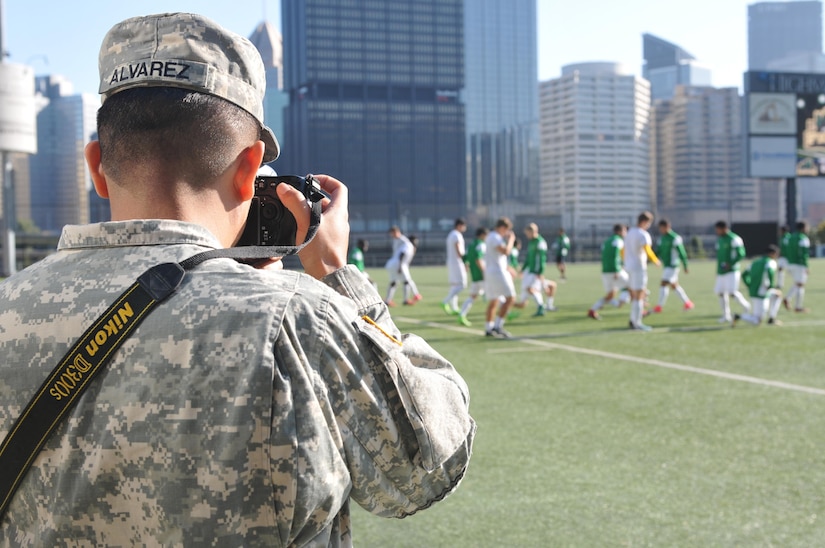 Spc. Miguel Alvarez, assigned to 354th MPAD, Coraopolis, Pennsylvania, photographs the Point Park University's men's soccer team during a training exercise September 5, 2017. The 354 MPAD used the Point Park University's military appreciation game as an opportunity to conduct soldier training for photography and videography.