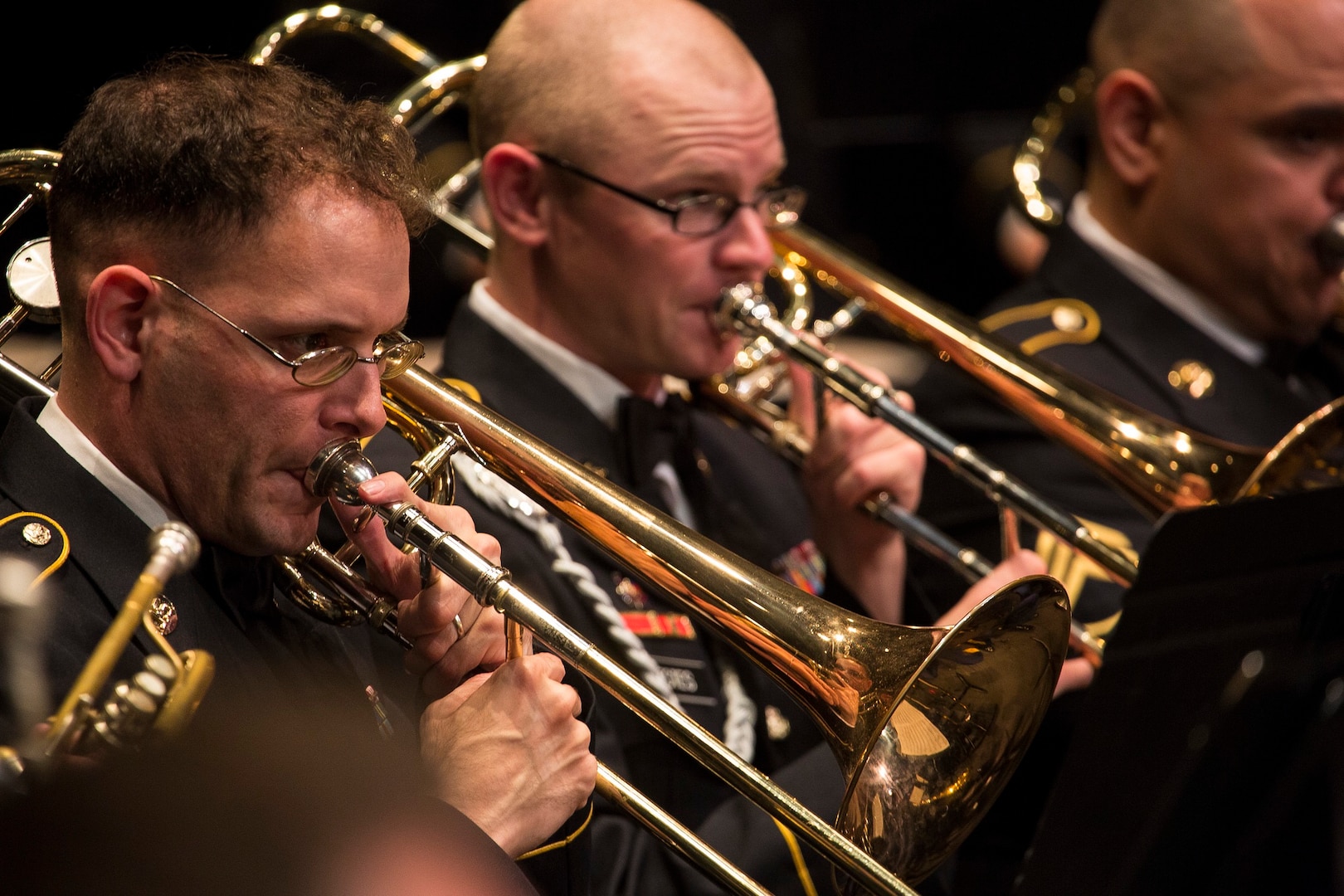 Sgt. Jonathan Solby (left) and Sgt. Daniel Estes (right), trombonists with the 323d Army Band at Joint Base San Antonio-Fort Sam Houston, perform at the Watson Fine Arts Center as part of the San Antonio Youth Wind Ensemble Performance April 13. The 323rd Army Band’s final reunion concert – scheduled for Sept. 24 at the Alamo – signifies the impending dissolution of the unit by fall of 2018.