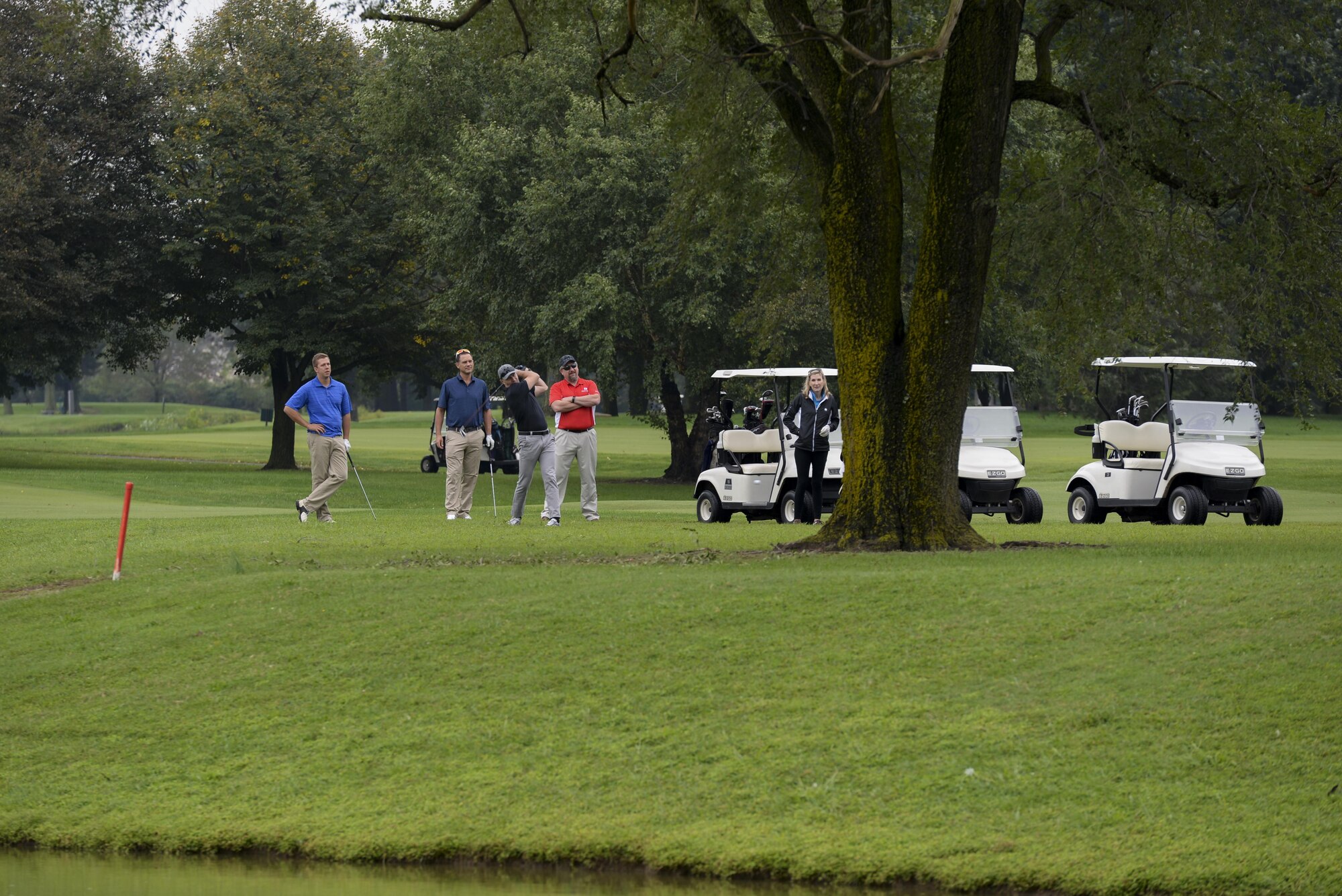 A golf team watches as Lt. Col. Edward Szczepanik, 436th Airlift Wing chief of safety, drives the ball Sept. 7, 2017, during the Bluesuiters’ Golf Tournament at Eagle Creek Golf Course on Dover Air Force Base, Del. Contestants were split into teams of four consisting of both military members and civilians. (U.S. Air Force photo by Staff Sgt. Aaron J. Jenne)