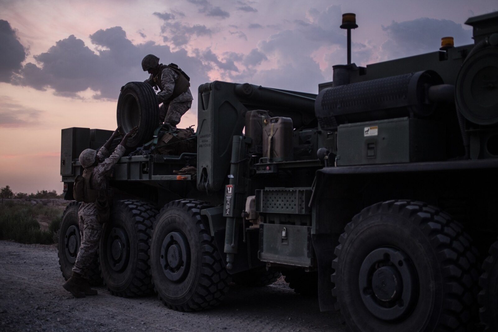 U.S. Marines with Bridge Company, 7th Engineer Support Battalion, 1st Marine Logistics Group, prepare to secure extra concertina wire on a Logistics Vehicle System Replacement truck during Exercise Deep Strike II at Blythe, Calif., September 6, 2017. Logistics Vehicle System Replacement trucks are one of various different vehicles used to transport large amounts of supplies or other vehicles that attribute to the logistical capabilities of the MLG. (U.S. Marine Corps photo by Lance Cpl. Timothy Shoemaker)