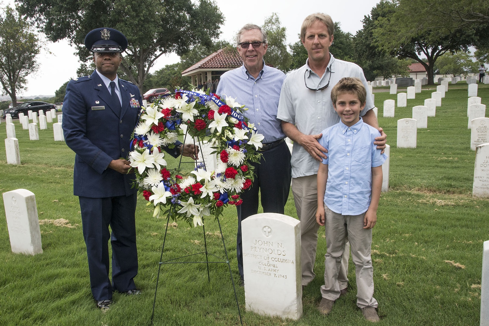 Lt. Col. Christopher Robinson, 91st Cyberspace Operations Squadron Commander, lays flowers on the grave of founding squadron commander Col. John Reynolds alongside members of Reynolds’ family Aug. 24 at Joint Base San Antonio-Fort Sam Houston, Texas. The 91st COS began on Aug. 20, 1917 as the 91st Aero Squadron under Col Reynolds’ command, a full 100 years ago. (US Air Force photo/Olivia Mendoza)