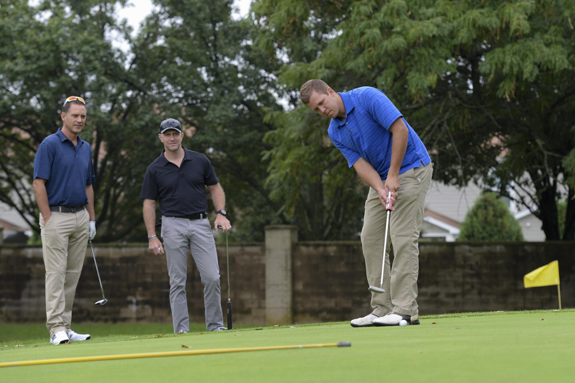 Maj. Rob Willoughby, 436th Airlift Wing deputy chief of safety, putts a golf ball as Col. Ethan Griffin, 436th AW commander, and Lt. Col. Ed Szczepanik, 436th AW chief of safety, look on Sept. 7, 2017, during the Bluesuiters’ Golf Tournament at Eagle Creek Golf Course on Dover Air Force Base, Del. The scramble tournament allowed each member to hit the ball and the entire team to play from the best position. (U.S. Air Force photo by Staff Sgt. Aaron J. Jenne)