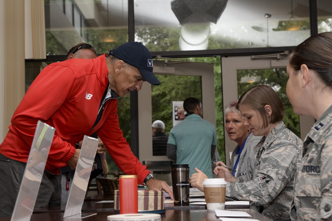 Mike Tatoian purchases a golf ball to participate in the 50/50 ball drop contest Sept. 7, 2017, during the Bluesuiters’ Golf Tournament at Eagle Creek Golf Course on Dover Air Force Base, Del. The biannual scramble tournament also featured a raffle, door prizes and a lunch at Mulligans. (U.S. Air Force photo by Staff Sgt. Aaron J. Jenne)