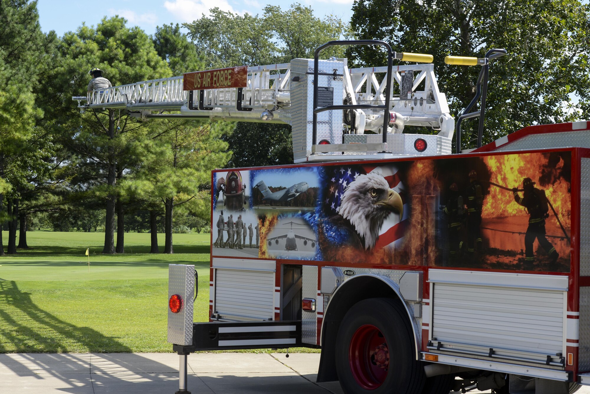 Senior Airman Wilson Rodriguez, 436th Civil Engineer Squadron firefighter, prepares to drop numbered golf balls from the extended ladder of a firetruck Sept. 7, 2017, during the Bluesuiters’ Golf Tournament at Eagle Creek Golf Course on Dover Air Force Base, Del. The ball drop event closed out the tournament. (U.S. Air Force photo by Staff Sgt. Aaron J. Jenne)