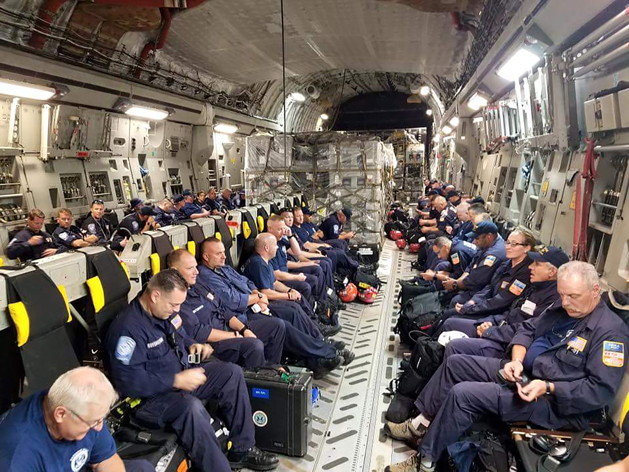 Members of the New York Task Force-1 prepare to board a 445th Airlift C-17 Globemaster III at Robins Air Force Base, Georgia September 8 and were bound for San Juan, Puerto Rico. The group, composed of FDNY and NYPD members trained to respond to catastrophic events, will assist those affected by Hurricane Irma. (Photo credit: NYC Emergency Management)