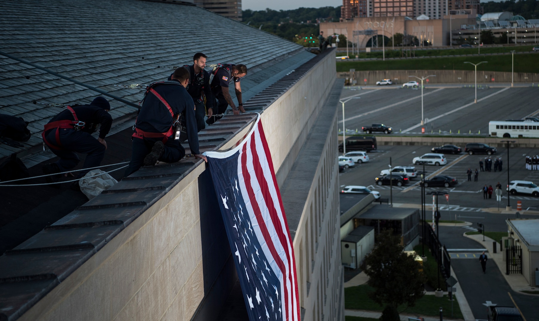 Pentagon workers unfurl a large American flag over the west side of the Pentagon at sunrise, Sept. 11, 2017, on the 16th anniversary of the 9/11 terrorist attacks. During the attacks, 184 people were killed when American Airlines Flight 77 crashed into the western side of the Pentagon near Corridor 4. DoD photo by Air Force Tech. Sgt. Brigitte N. Brantley