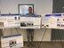 Col. Phillip Goff holding research posters from Team Aerospace Operations Solutions conference.