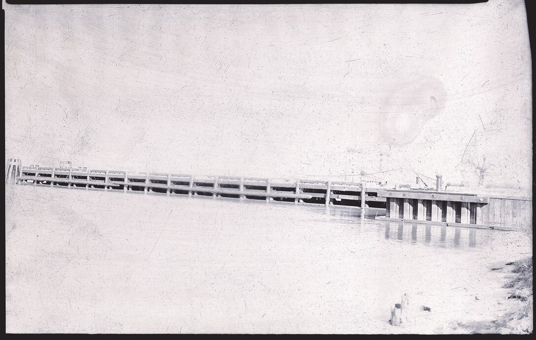 IMAGE: 12/15/1944
MARITIME HISTORY: Naval Proving Ground (NPG)- Dock at Berbers Point NOy 9651- Specs 14156 Diamond Construction Co.
View showing up-stream side of dock and steel pile bulkhead. Tide Bridge by NPG.