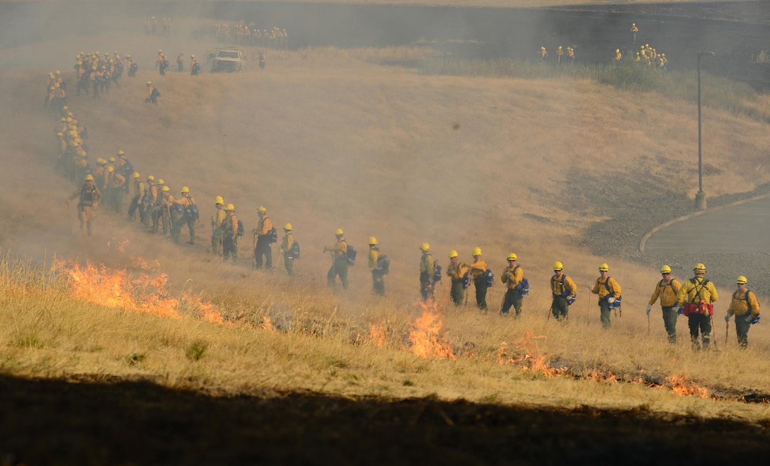 Oregon Army National Guardsmen from the 41st Infantry Brigade Combat Team watch a controlled burn during a field training exercise at the Oregon Department of Public Safety Standards and Training in Salem, Ore., Aug. 28, 2017. Oregon Army National Guard photo by Sgt. 1st Class April Davis