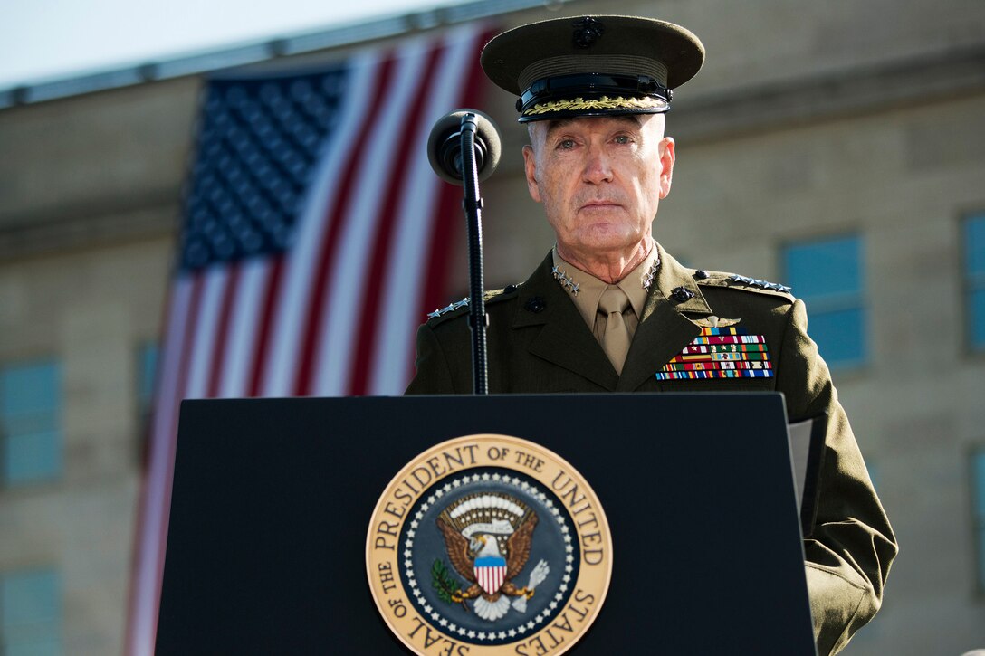 Marine Corps Gen. Joe Dunford, chairman of the Joint Chiefs of Staff, stands at a podium with the Pentagon in the background.
