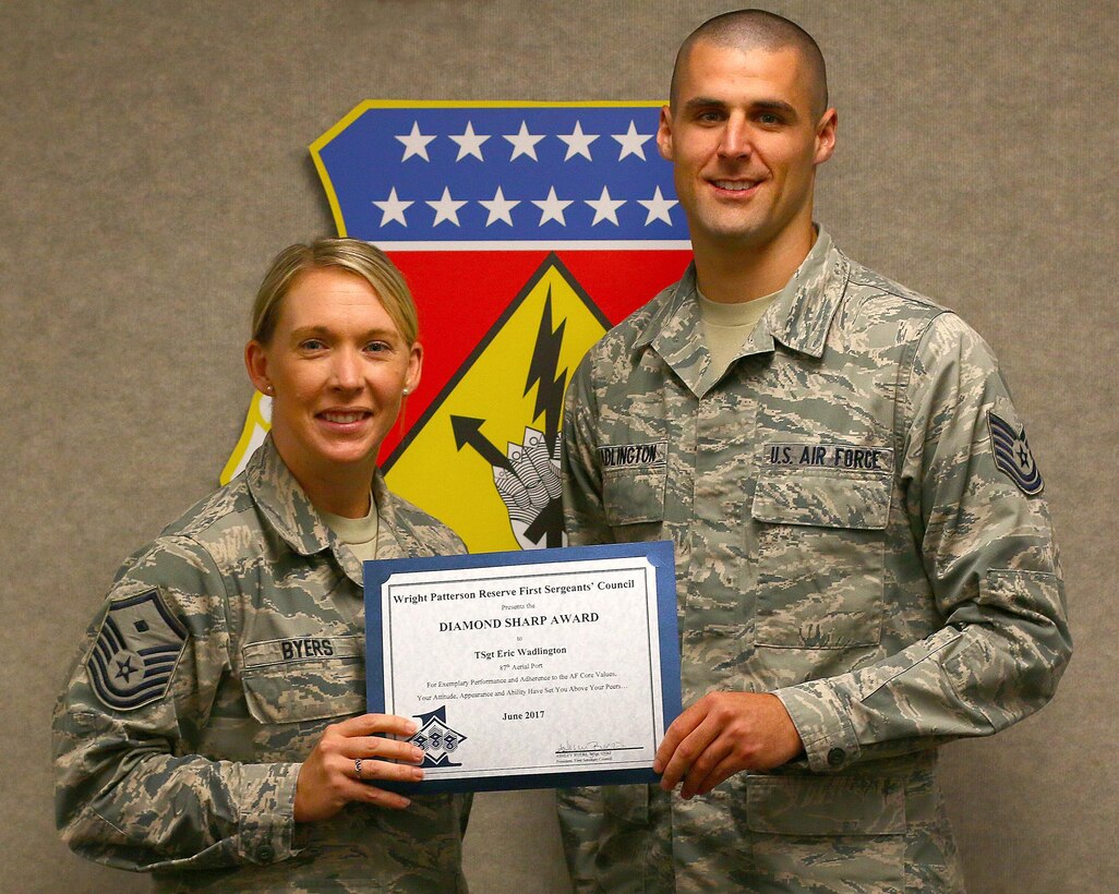Master Sgt. Ashley Byers, 14th Intelligence Squadron first sergeant, presents the June 2017 Diamond Sharp Award to Tech. Sgt. Eric Wadlington, 87th Aerial Port Squadron, August 5, 2017. The award is for exemplary performance, adherence to the Air Force Core Values, attitude, appearance and ability. (U.S. Air Force photo/Master Sgt. Patrick O’Reilly)