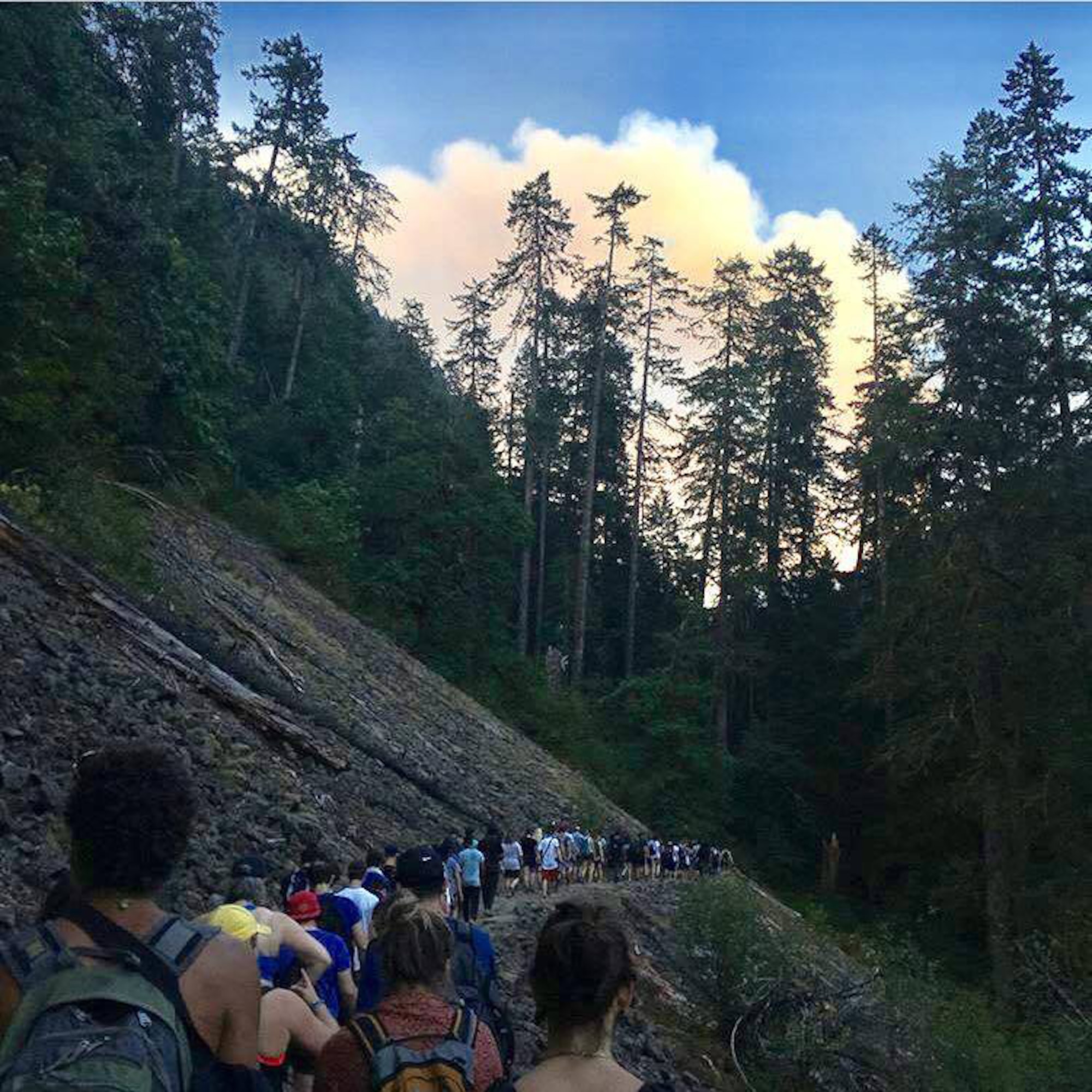 Hikers head away from the Eagle Creek Trail toward the Indian Creek Fire plume in the Columbia River Gorge near Portland, Ore., on Sept. 2, 2017.  Tech. Sgt. Robert Dones, 349th Medical Squadron surgical technician, helped guide the group safely out of the fire. (U.S. Air Force courtesy photo provided by Sarah Carlin Ames)