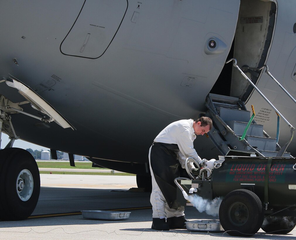 Staff Sgt. Rodney McElfresh, 445th Aircraft Maintenance Squadron crew chief, services liquid oxygen into a C-17 Globemaster III here August 9, 2017. Liquid oxygen is converted to gas in the aircraft which is then used for aircrew in case of emergency as well as for Aeromedical Evacuation patients when in transport. (U.S. Air Force photo/Master Sgt. Patrick O’Reilly)