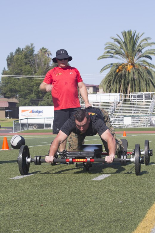 Lance Cpl. Mason McGuff, administrative specialist, air control training squadron, Marine Corps Communication Electronics School, performs a 25-yard movement on the Frog Fitness Frog Total Body Resistance Trainer during a High Intensity Tactical Training Tactical Athlete Championship at the 11 Area Football Field aboard Marine Corps Base Camp Pendleton, Calif., August 30, 2017. The fast paced competition challenged participants mentally and physically to become fit and adaptable Marines capable of fighting in any clime and place. (U.S. Marine Corps photo by Pfc. Margaret Gale)
