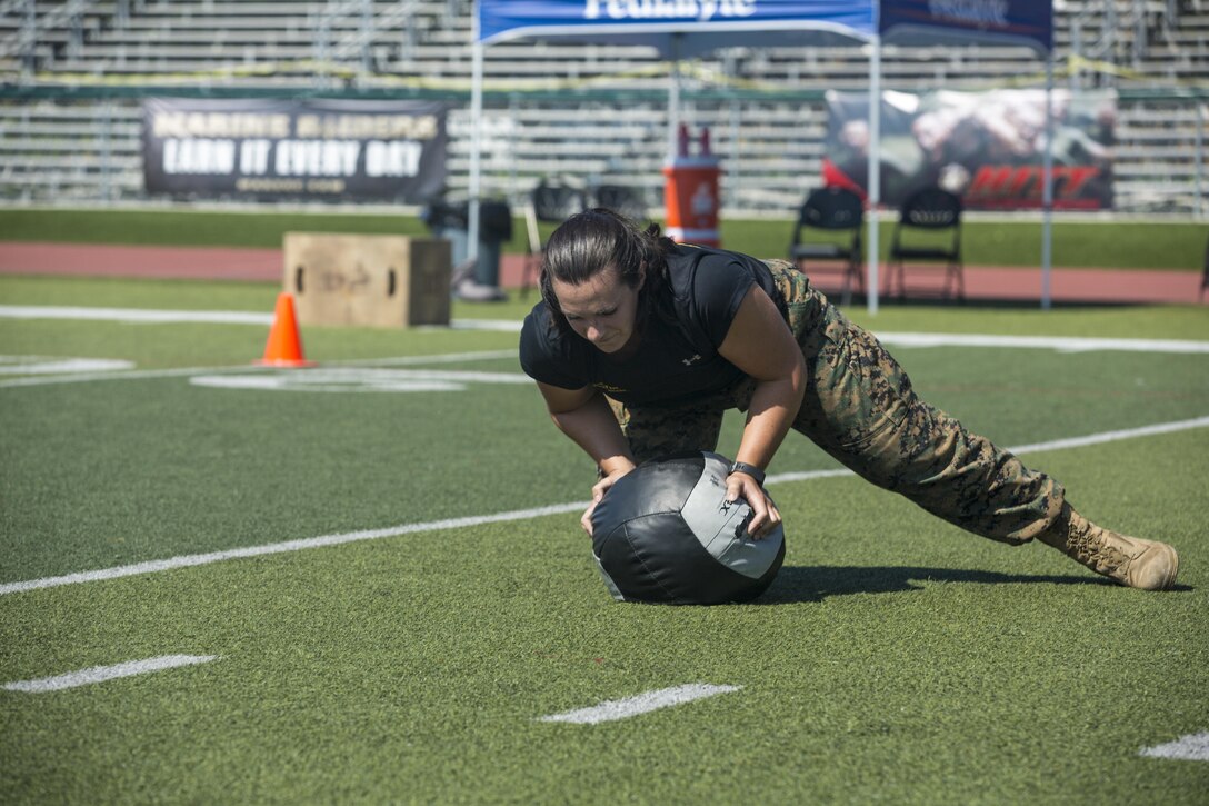 1st Lt. Margo Smutnick, manpower officer, Marine Corps Air Ground Task Force adjutant, performs 10 plyo pushups on a medicine ball during a High Intensity Tactical Training Tactical Athlete Championship at the 11 Area Football Field aboard Marine Corps Base Camp Pendleton, Calif., August 30, 2017. The fast paced competition challenged participants mentally and physically to become fit and adaptable Marines capable of fighting in any clime and place. (U.S. Marine Corps photo by Pfc. Margaret Gale)