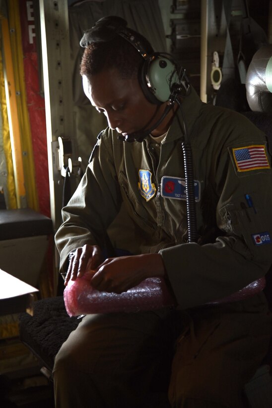 Tech. Sgt. Karen Moore, a loadmaster for the 53rd Weather Reconnaissance Squadron, prepares a dropsonde to be released into the eyewall of Hurricane Irma. Crews have recently been flying missions continuously in three different hurricanes in the Atlantic region simultaneously. (U.S. Air Force photo by: Staff Sgt. Nicholas Monteleone)