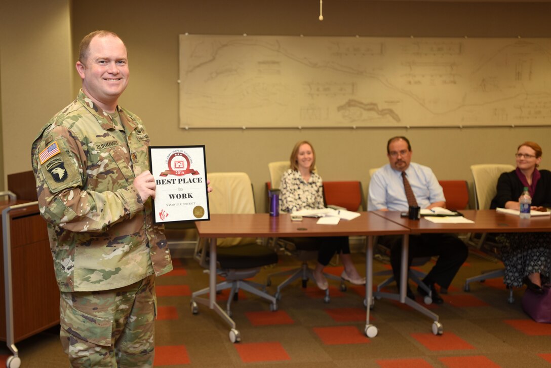 Maj. Christopher Burkhart, U.S. Army Corps of Engineers Nashville District deputy commander, shows off the "Best Place to Work in USACE" Award at the district's staff meeting Sept. 11, 2017 in Nashville, Tenn.  The award was in the medium size agency category based on employee responses in the 2016 Federal Employee Viewpoint Survey.  Nine awards were presented by the U.S. Army Corps of Engineers Headquarters to organizations in this category.