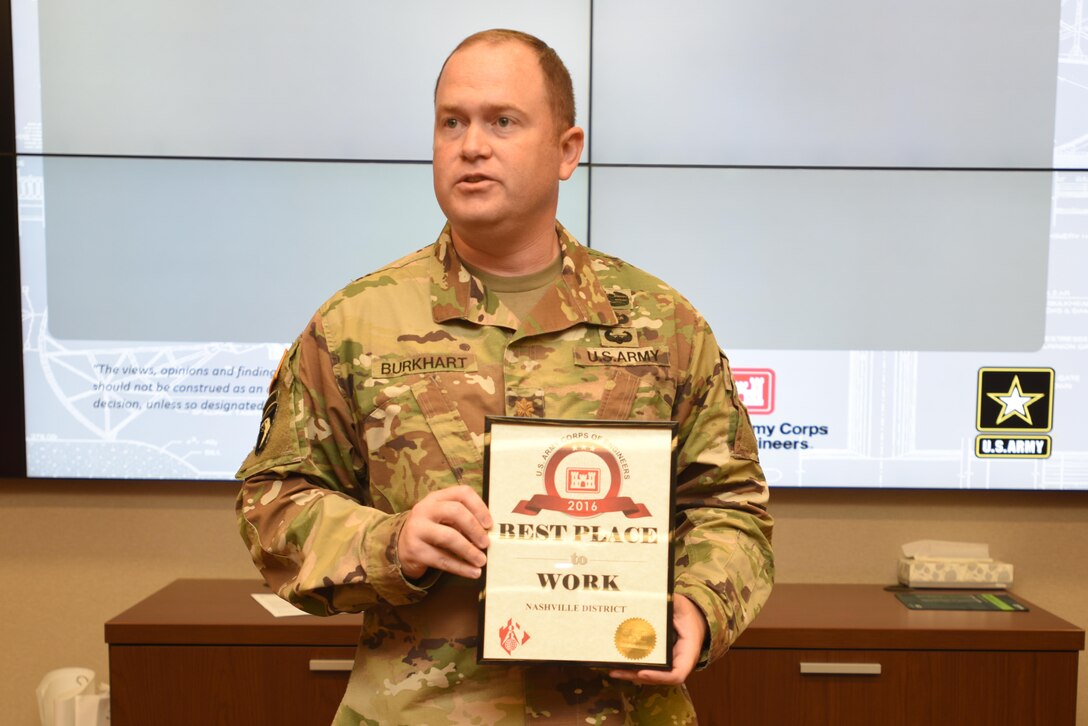 Maj. Christopher Burkhart, U.S. Army Corps of Engineers Nashville District deputy commander, shows off the "Best Place to Work in USACE" Award at the district's staff meeting Sept. 11, 2017 in Nashville, Tenn.  The award was in the medium size agency category based on employee responses in the 2016 Federal Employee Viewpoint Survey.  Nine awards were presented by the U.S. Army Corps of Engineers Headquarters to organizations in this category.