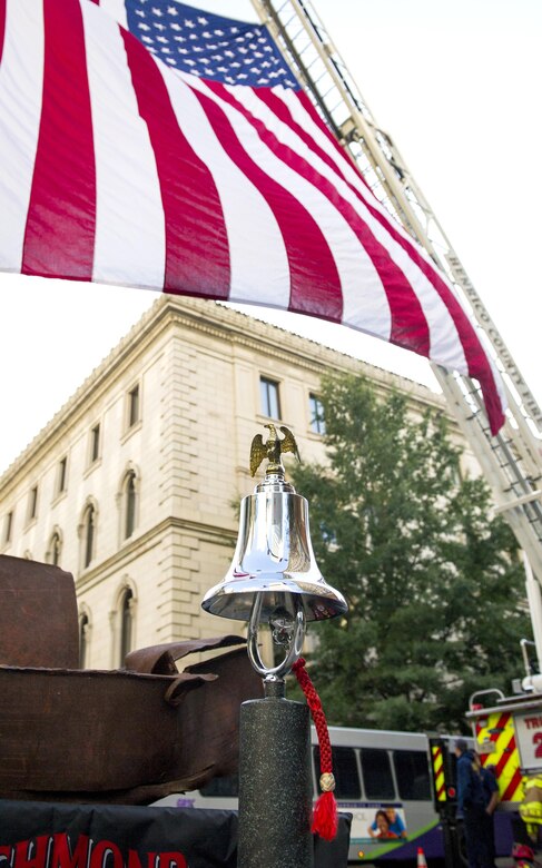 A fire bell sits under the American flag in downtown Richmond