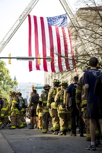 A group procession of first responders walk toward the SunTrust Center in Richmond, Va