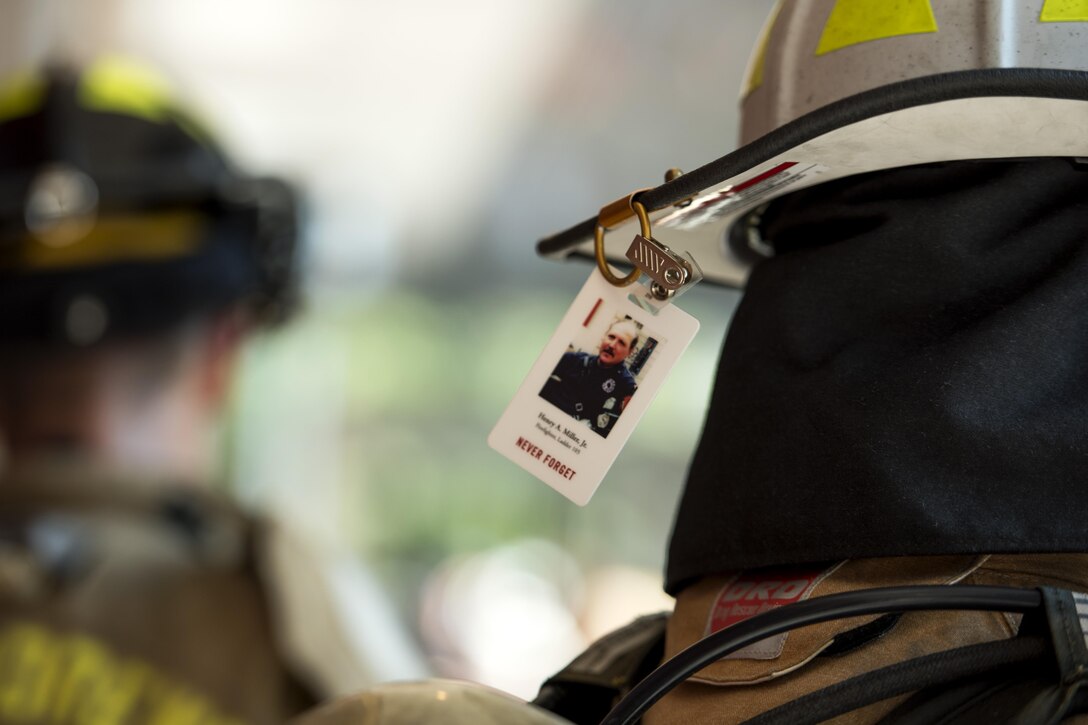 A 2017 Richmond 9/11 Memorial Stair Climb participant carries a badge with a photo of Henry A. Miller, Jr., a first responder