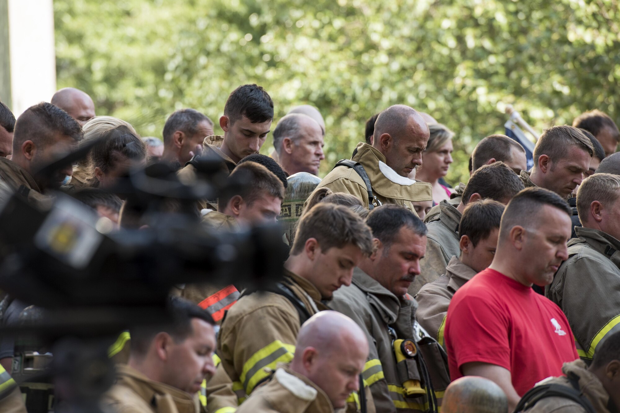 Participants of the 2017 Richmond 9/11 Memorial Stair Climb bow their heads in prayer