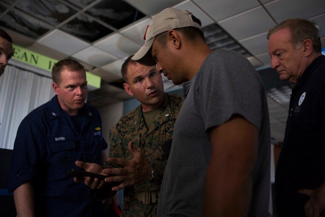U.S. Marine Corps Lt. Col. Marcus J. Mainz, center, battalion commander of Battalion Landing Team 2nd Battalion, 6th Marine Regiment, 26th Marine Expeditionary Unit (MEU), explains relief assets of the 26th MEU to a logistics representative from Federal Emergency Management Assistance (FEMA) in St. Thomas, U.S. Virgin Islands, Sep. 10, 2017. The 26th MEU is supporting the lead federal agency in providing humanitarian relief efforts for Hurricane Irma. (U.S. Marine Corps photo by Lance Cpl. Santino D. Martinez)