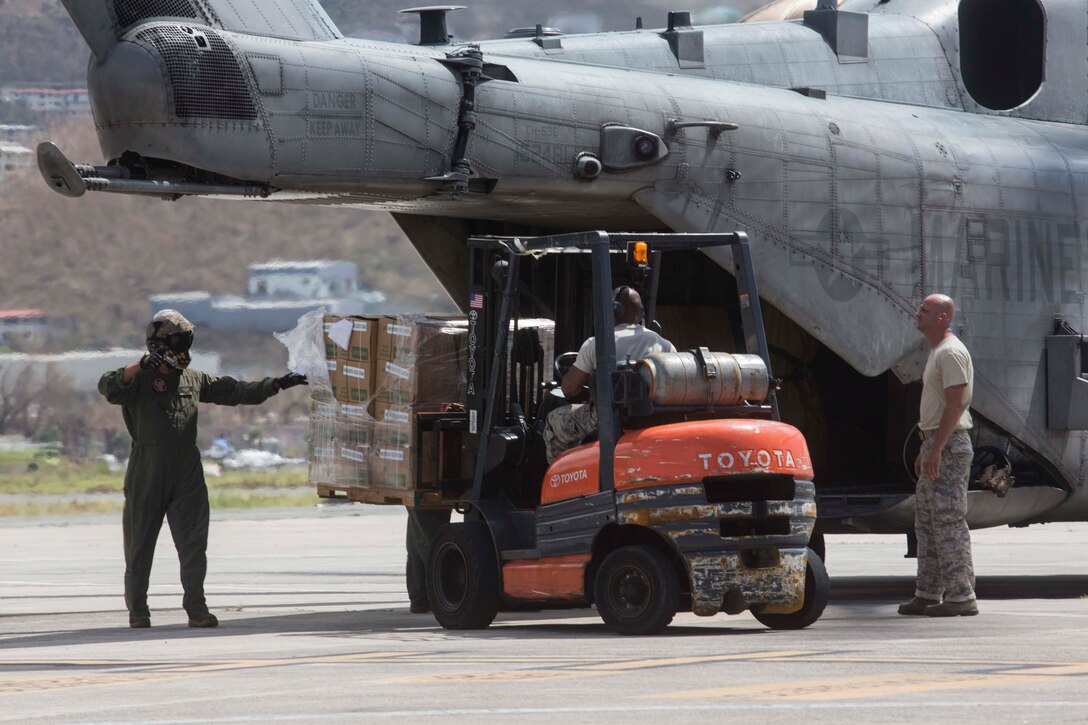 U.S. Marines with the 26th Marine Expeditionary Unit, and U.S. Airmen with the 146th Air Lift Wing, unload humanitarian resources from a CH-53 Super Stallion helicopter with the 26th MEU, to support relief efforts in St. Thomas, U.S. Virgin Islands, Sep. 10, 2017. The 26th MEU is supporting the lead federal agency in providing humanitarian relief efforts for Hurricane Irma. (U.S. Marine Corps photo by Lance Cpl. Santino D. Martinez)