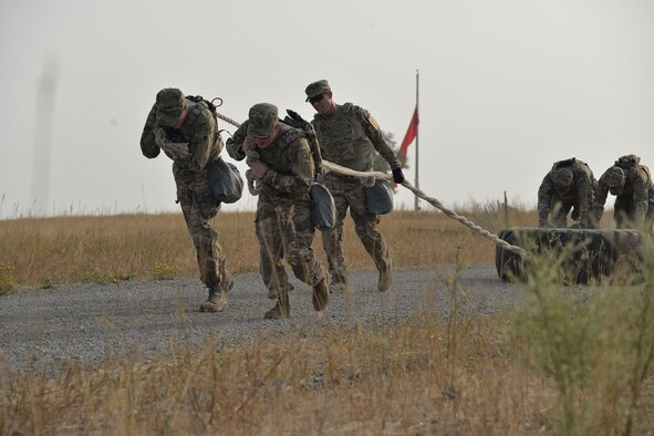 A team of security forces Airmen pull a tire during the annual Aces Cop Combat Challenge Sept. 8, 2017, at Malmstrom Air Force Base, Mont. The tire pull was one of 11 obstacles during the competition. (U.S. Air Force photo/Airman 1st Class Daniel Brosam)