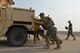 A team of security forces Airmen push a Humvee during the annual Aces Cop Combat Challenge Sept. 8, 2017, at Malmstrom Air Force Base, Mont. Teams had to push the Humvee from one side of the flight line to the other. (U.S. Air Force photo/Airman 1st Class Daniel Brosam)