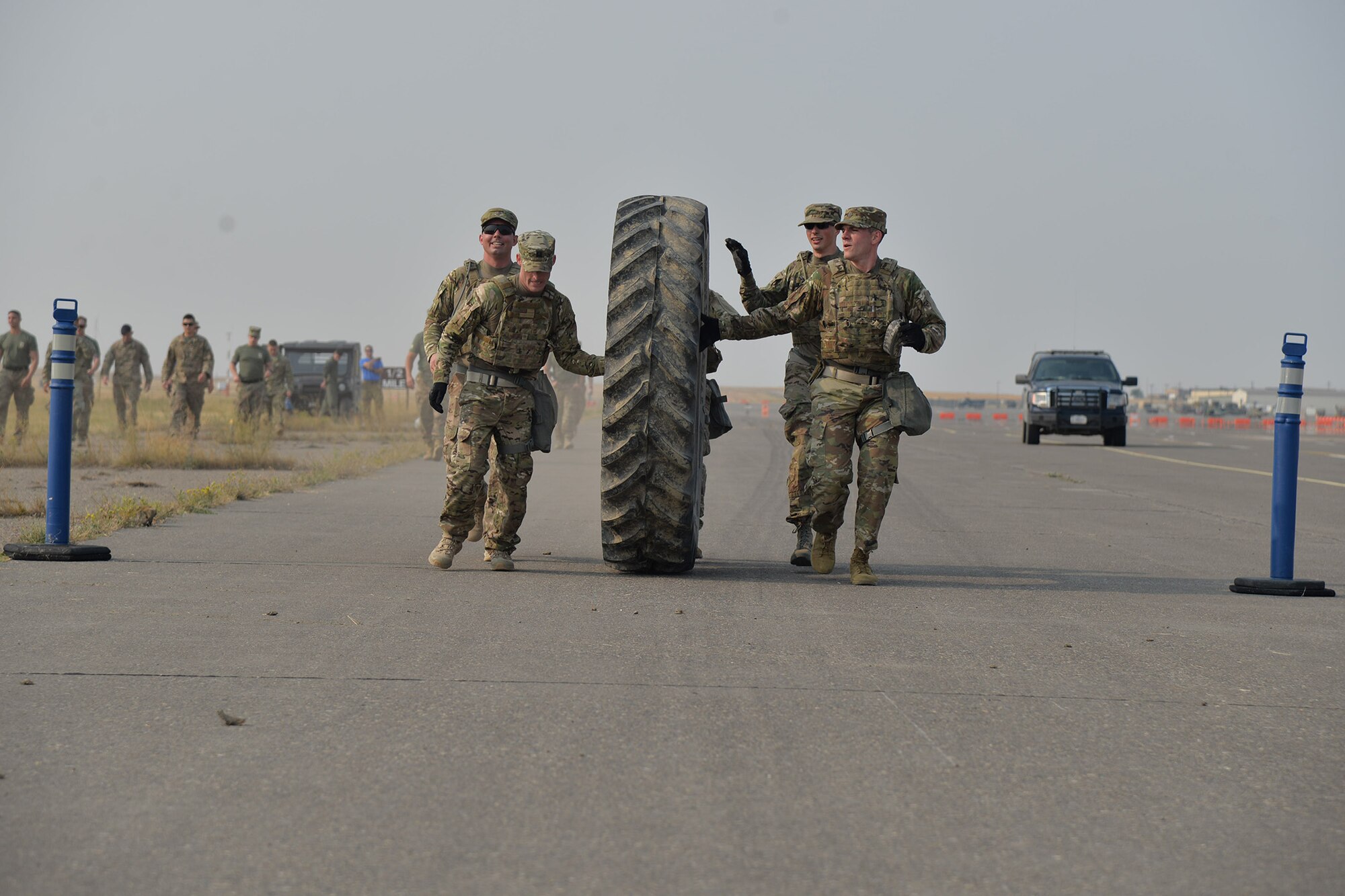 A team of security forces Airmen roll a tire down the flight line during the annual Aces Cop Combat Challenge Sept. 8, 2017, at Malmstrom Air Force Base, Mont. Thirteen teams of defenders from the 341st Security Forces Group participated in the annual competition. (U.S. Air Force photo/Airman 1st Class Daniel Brosam)