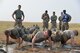 A team of security forces Airmen perform group pushups at the ‘Team Pain’ obstacle during the annual Aces Cop Combat Challenge Sept. 8, 2017, at Malmstrom Air Force Base, Mont. During this obstacle, teams had to complete as many group pushups as possible within two minutes. (U.S. Air Force photo/Airman 1st Class Daniel Brosam)