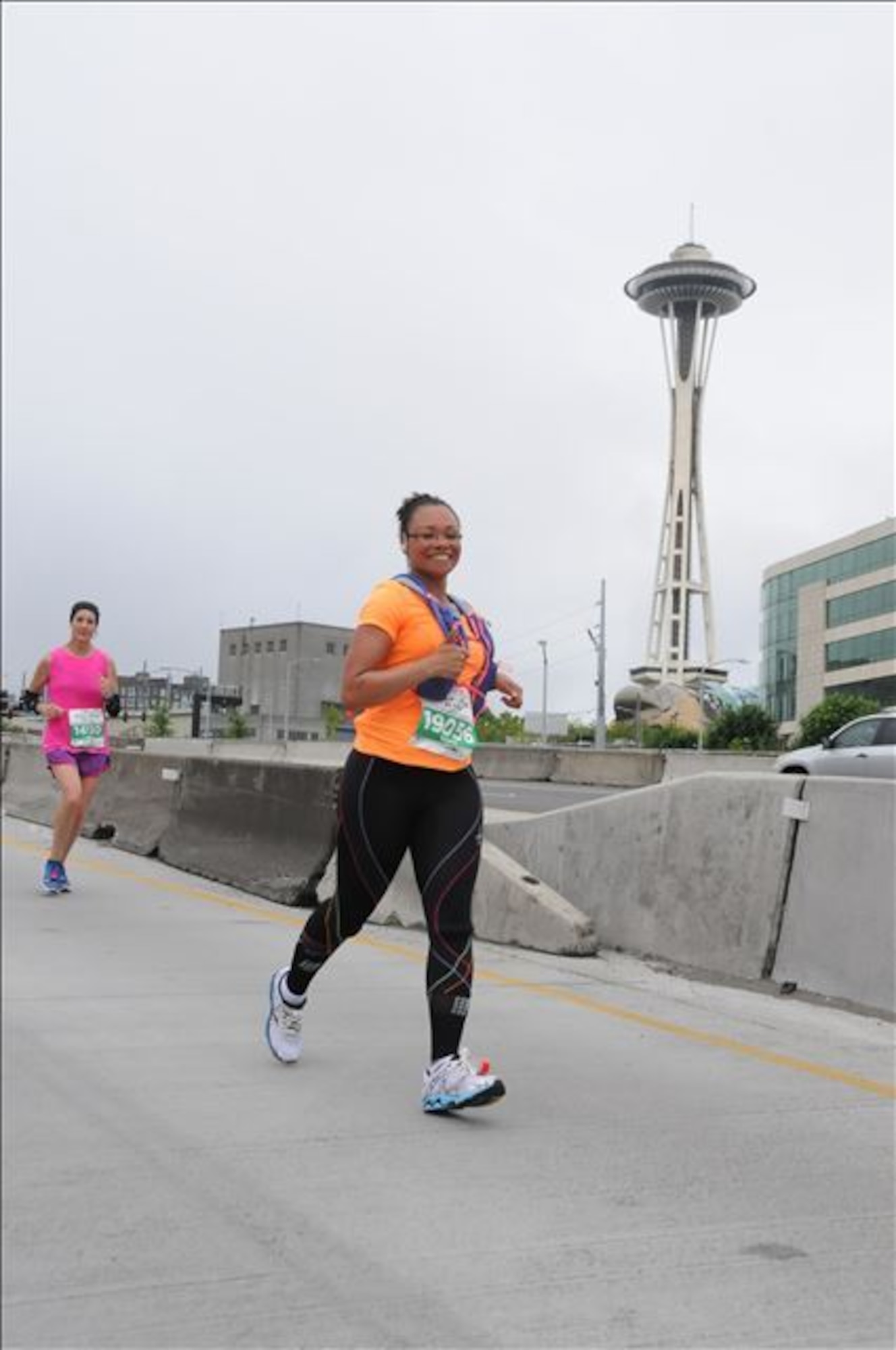Lt. Col. Tammy Dotson, 21st Mission Support Group deputy commander, runs past the iconic Space Needle during the Seattle Marathon June 18, 2017. She ran this race the day after completing a half marathon in Anchorage, Alaska. Dotson has a goal to complete a half marathon in all 50 states. (Courtesy photo)