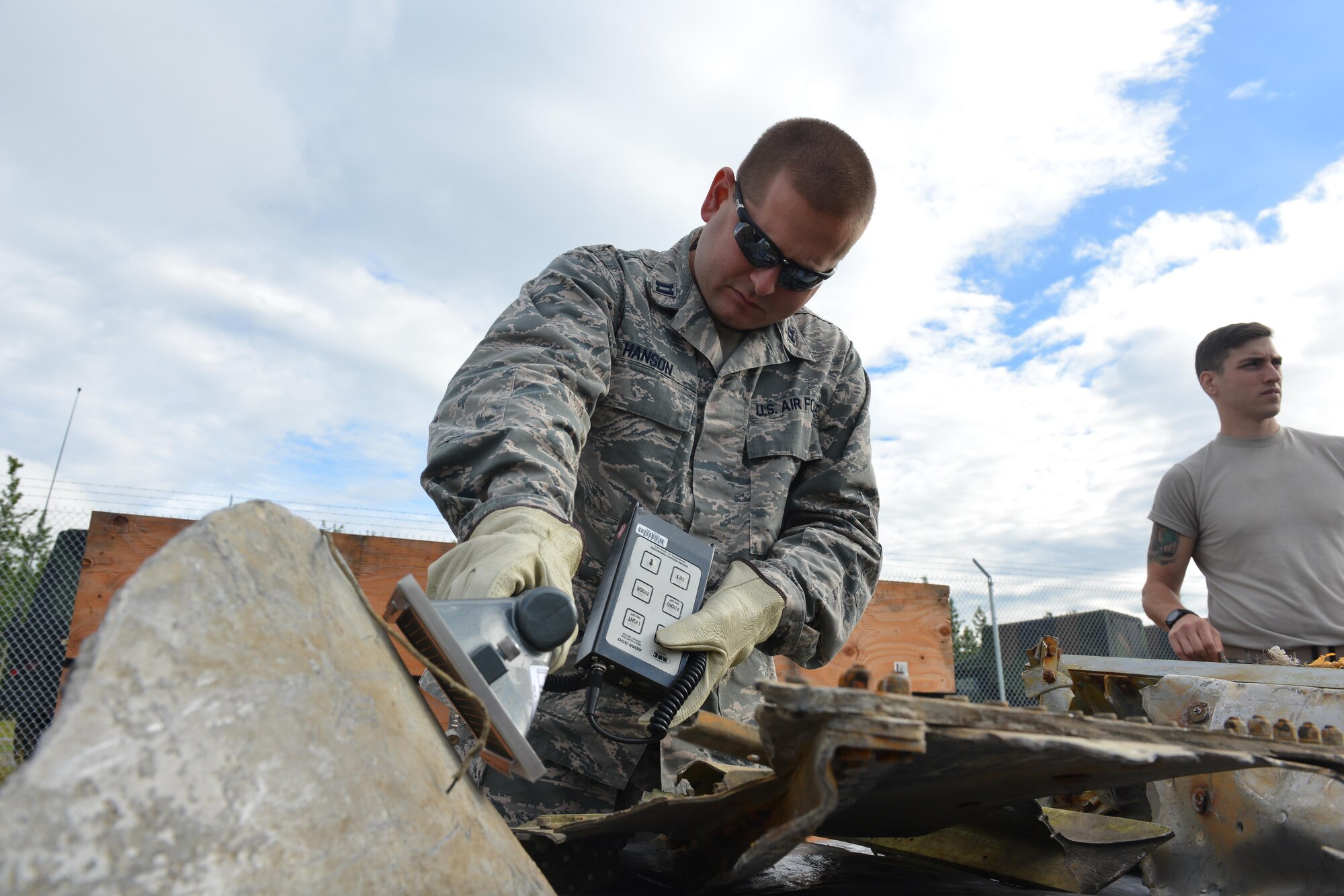 Airmen from the 673d Medical Group's Bioenvironmental Engineering Flight unload scrap metal from shipment boxes on the Bryant Army Airfield July 20, 2017.
