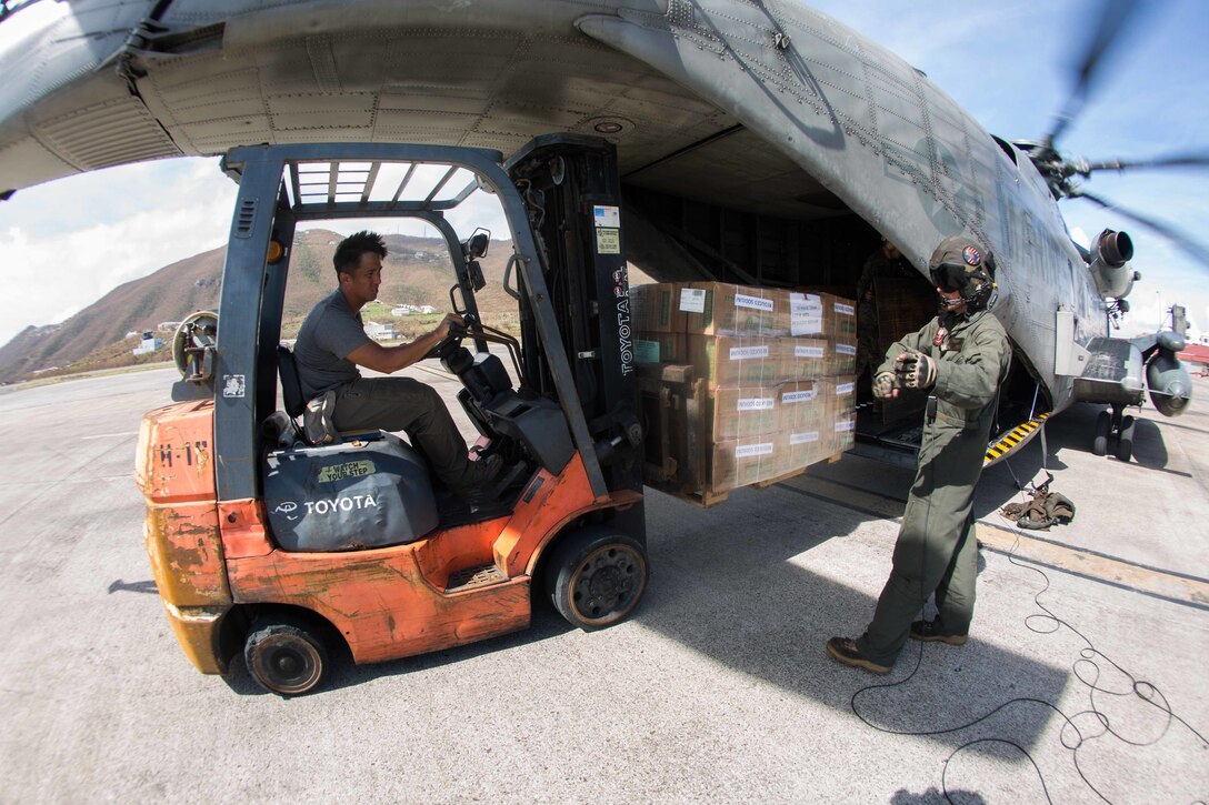 U.S. Marines with the 26th Marine Expeditionary Unit (MEU), and U. S.  Air Force Airmen, unload a CH-53E Super Stallion helicopter with Marine Medium Tiltrotor Squadron (VMM) 162 (Reinforced), 26th MEU, at the St. Thomas Cyril King E. Airport, U.S. Virgin Islands, Sept. 10, 2017. The 26th MEU is supporting authorities in the U.S. Virgin Islands with the combined goal of protecting the lives and safety of those in affected areas.