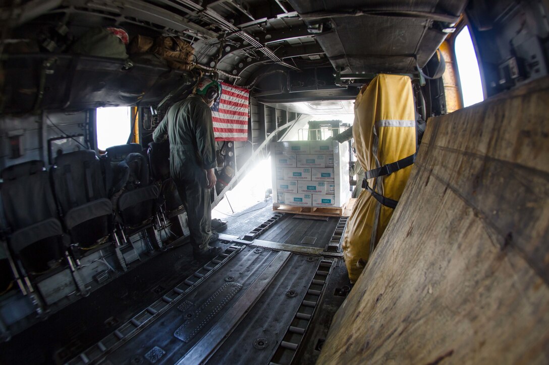 U.S. Marines with the 26th Marine Expeditionary Unit (MEU), and U.S. Air Force Airmen, unload a CH-53E Super Stallion with Marine Medium Tiltrotor Squadron (VMM) 162 (Reinforced), 26th MEU, at the St. Thomas Cyril King E. Airport, U.S. Virgin Islands, Sept. 10, 2017. The 26th MEU is supporting authorities in the U.S. Virgin Islands with the combined goal of protecting the lives and safety of those in affected areas.