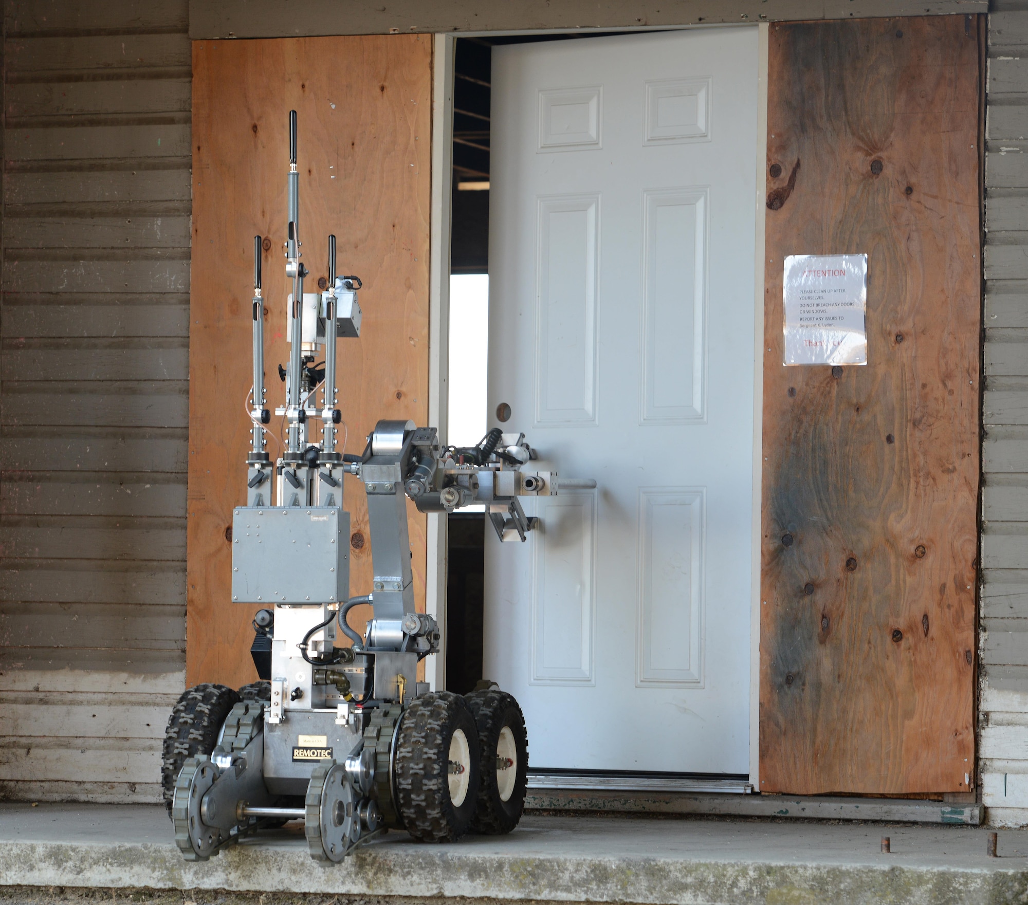 A robot controlled by 9th Civil Engineer Squadron explosive ordnance technicians opens a door during Urban Shield
