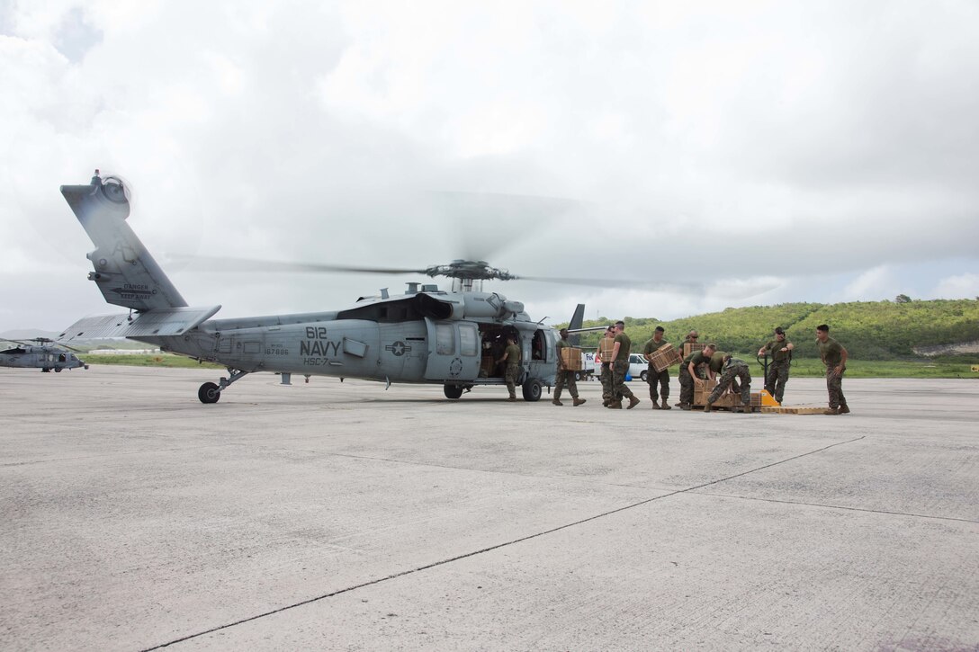 U.S. Marines with the Battalion Landing Team 2nd Battalion, 6th Marine Regiment, 26th Marine Expeditionary Unit (MEU), unload emergency care items from a U.S. Navy MH-60S Seahawk helicopter with Helicopter Sea Combat Squadron 7, at the Henry E. Rohlsen Airport in St. Croix, U.S. Virgin Islands, Sept. 11, 2017. Marines worked alongside joint Department of Defense forces and Federal Emergency Management Agency to provide food, water, and other essential care items in support of Hurricane Irma relief efforts. (U.S. Marine Corps photo by Lance Cpl. Alexis C. Schneider)