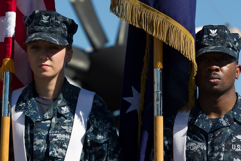Service members from several partner nations sit atop the flight deck during the closing ceremony of Exercise Talisman Saber 17 aboard the USS Ronald Reagan (CVN 76), ported in Brisbane, Queensland, Australia, July 25, 2017.