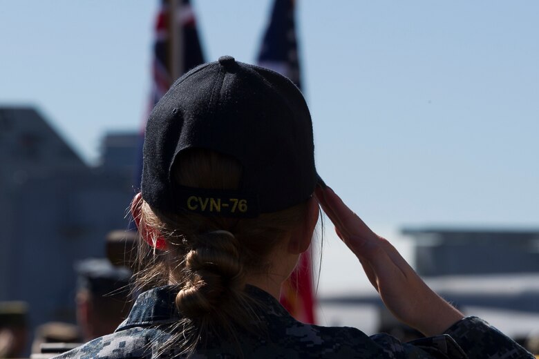 Service members from several partner nations sit atop the flight deck during the closing ceremony of Exercise Talisman Saber 17 aboard the USS Ronald Reagan (CVN 76), ported in Brisbane, Queensland, Australia, July 25, 2017.