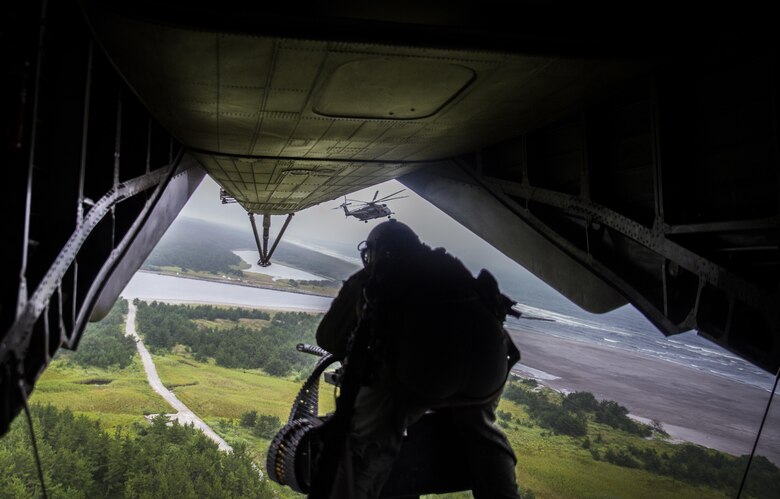 A crew chief checks for targets from the back of a CH-53E Super Stallion above Draughon Range near Misawa Air Base, Japan, August 21, 2017, in support of exercise Northern Viper 17. This combined-joint exercise is held to enhance regional cooperation between participating nations to collectively deter security threats. The crew chief is assigned to Marine Heavy Helicopter Squadron 462, Marine Aircraft Group 16, 3rd Marine Aircraft Wing, currently forward deployed under the Unit Deployment Program with Marine Aircraft Group 36, 1st MAW, based out of Okinawa, Japan. (U.S. Marine Corps photo by Lance Cpl. Andy Martinez)