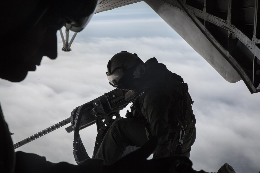 A crew chief adjust his gunner's belt from the back of a CH-53E Super Stallion above Draughon Range near Misawa Air Base, Japan, August 21, 2017, in support of exercise Northern Viper 17. This combined-joint exercise is held to enhance regional cooperation between participating nations to collectively deter security threats. The crew chief is assigned to Marine Heavy Helicopter Squadron 462, Marine Aircraft Group 16, 3rd Marine Aircraft Wing, currently forward deployed under the Unit Deployment Program with Marine Aircraft Group 36, 1st MAW, based out of Okinawa, Japan. (U.S. Marine Corps photo by Lance Cpl. Andy Martinez)