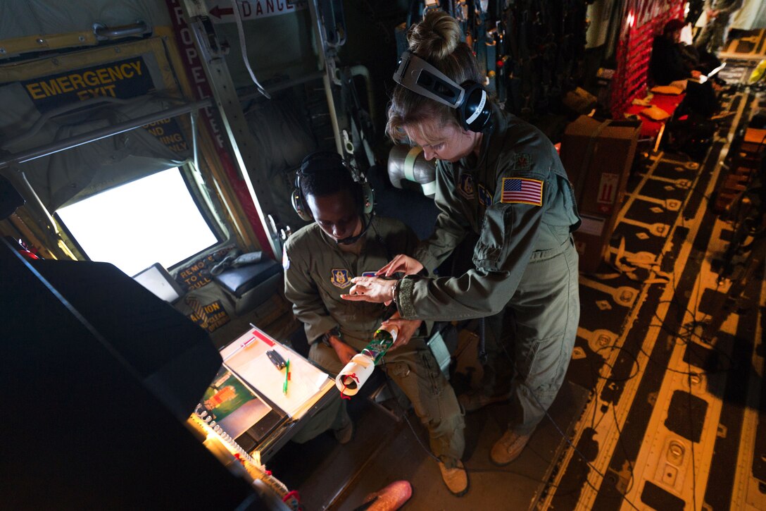 Two members of the Air Force inspect a piece of equipment