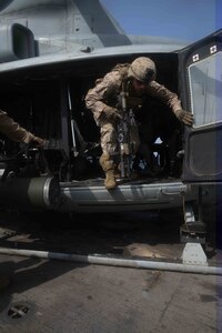 Marines with the 15th Marine Expeditionary Unit’s Battalion Landing Team 1/5, exit a UH-1Y Huey during a Tactical Recovery of Aircraft and Personnel air familiarization drill aboard USS San Diego (LPD 22) during exercise Alligator Dagger.