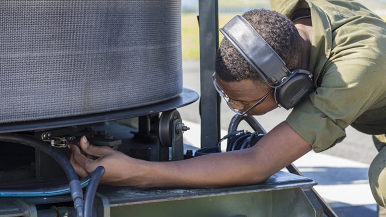 U.S. Marine Corps Cpl. Jeni Ridgell, an aircraft recovery Marine with Headquarters and Headquarters Squadron, watches a gauge on an M-31 Marine Corps Expeditionary Aircraft arresting gear during an annual certification at Marine Corps Air Station Iwakuni, Japan, Sept. 8, 2017.