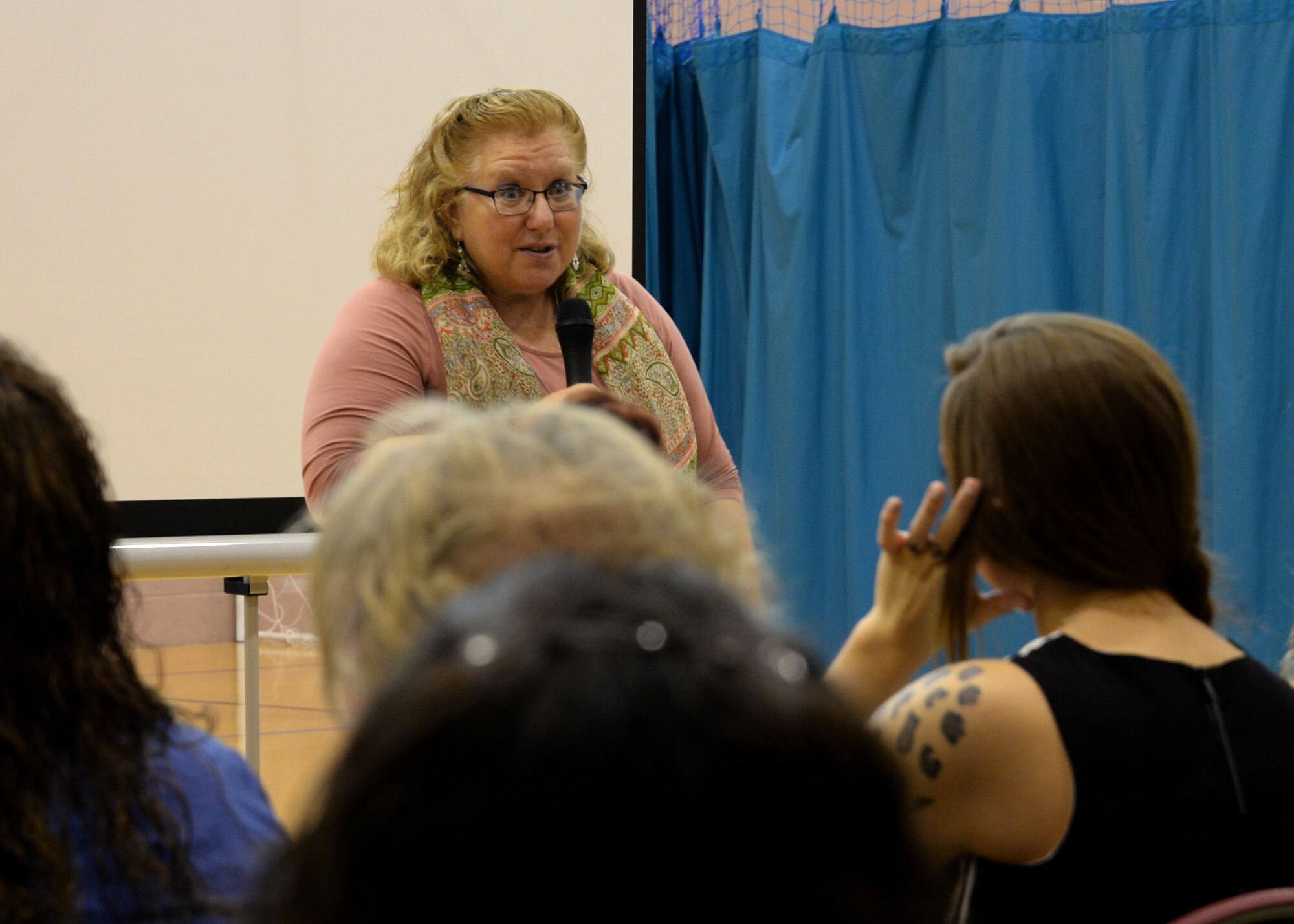 Susan Speroff, RAF Mildenhall Child Development Center Youth Program manager, greets participants of the U.K. Child and Youth Conference Sept. 9, 2017, at the Youth Center on RAF Mildenhall, England. Speroff was the key note speaker and shared with the crowd some experiences during her 36 years in education and child care. The conference offered various classes to better their abilities as child care educators and providers. (U.S. Air Force photo by Senior Airman Justine Rho)