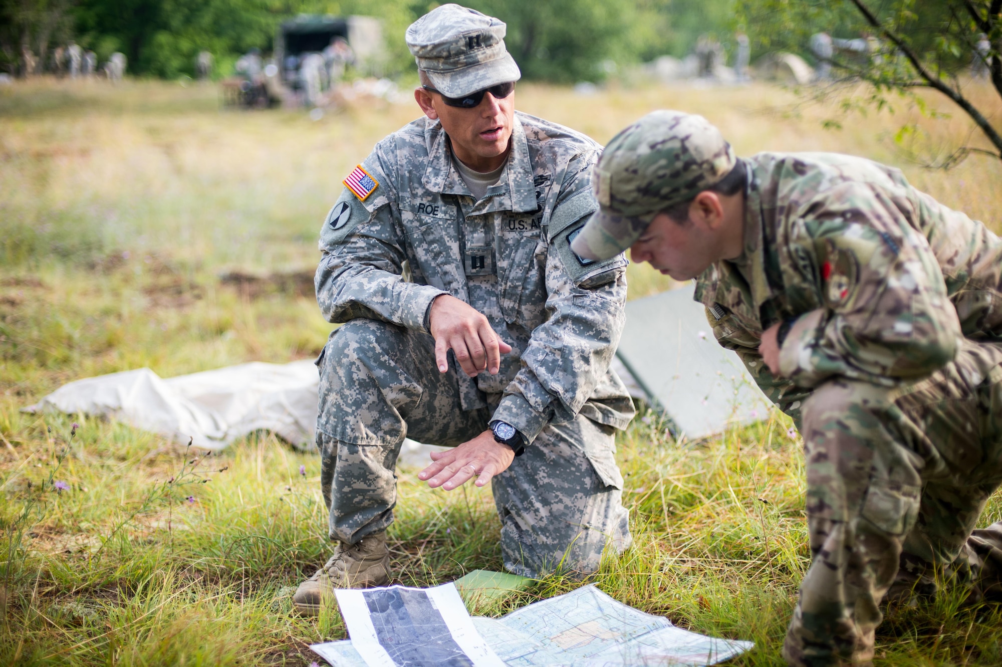 Capt. James Roe, Arizona Army National Guard A-158 Infantry commander, and Staff Sgt. Laurence Paradis, a tactical air control party specialist with the 146th Air Support Operations in Oklahoma City, plan the integration of close air support during a maneuvering exercise near near Camp Grayling Joint Maneuver Training Center, Mich., Aug. 2, 2017. Members of the 146 ASOS joined more than 50 other TACP specialists from NATO allies and U.S. forces to integrate with various sister services during Northern Strike 17 from July 31 to Aug. 11, 2017. (U.S. Air National Guard photo by Senior Airman Tyler Woodward)