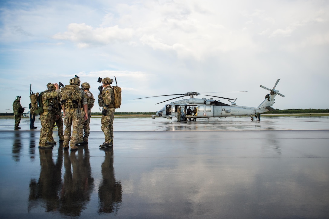 Tactical air control party specialists from the 146th Air Support Operations Squadron at Will Rogers Air National Guard Base in Oklahoma City await transportation on a U.S. Navy SH-60 Seahawk to a nearby range for an airborne controlling scenario at Camp Grayling, Mich., Aug. 6, 2017. The 146 ASOS members utilized the range to conduct close air support exercises at night while integrating with sister services. (U.S. Air National Guard photo by Senior Airman Tyler Woodward)