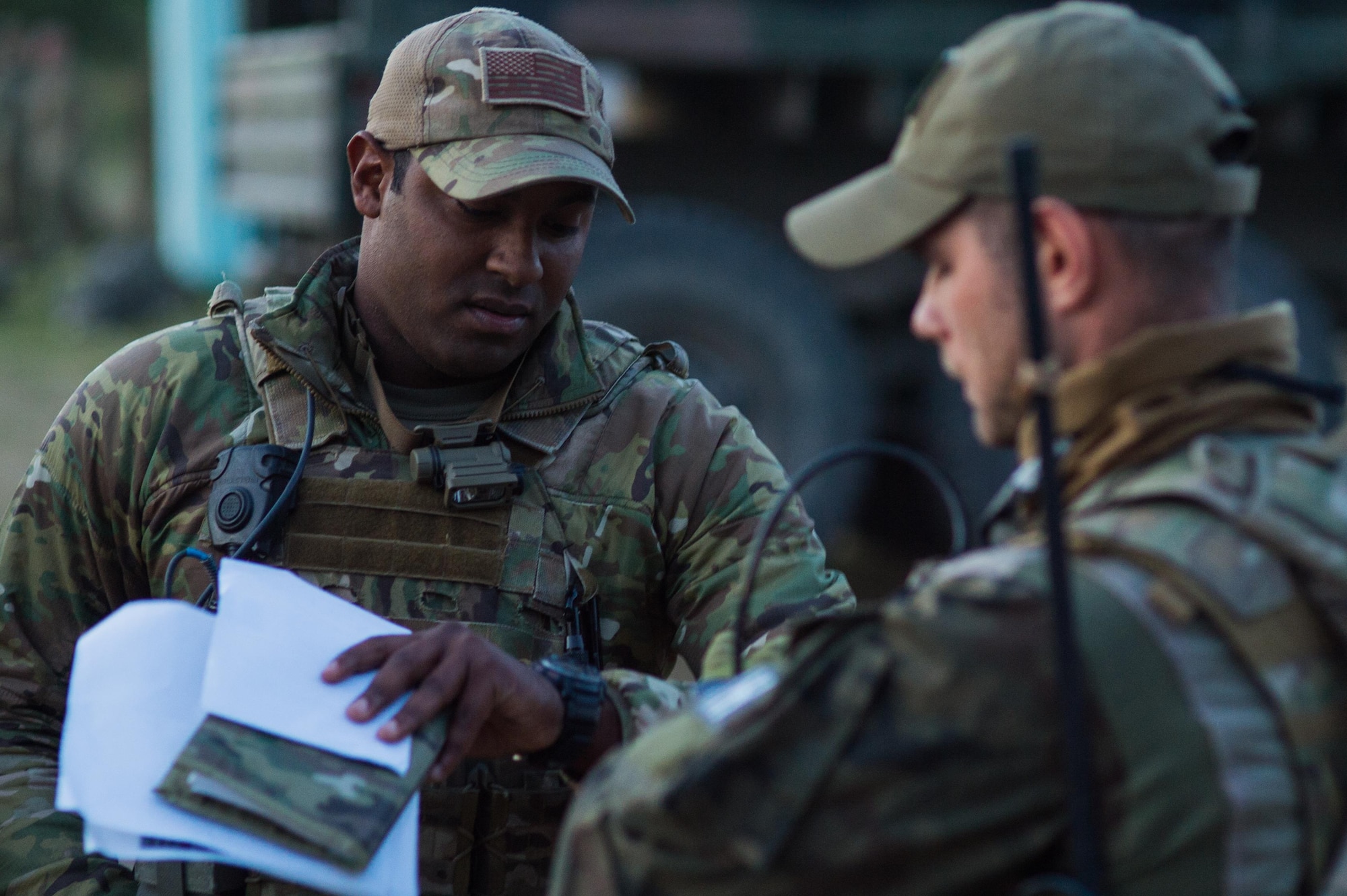 Staff Sgt. Sam Salcedo, a tactical air control party specialist with the 146th Air Support Operations Squadron in Oklahoma City, coordinates with the Poland 18th Airborne Battalion ground commander before a live-fire exercise while training at Northern Strike 17 at Camp Grayling, Michigan, Aug. 8, 2017. Tactical air control party specialists with the 146 ASOS provided close air support during the integrated scenario. (U.S. Air National Guard photo by Senior Airman Tyler Woodward)